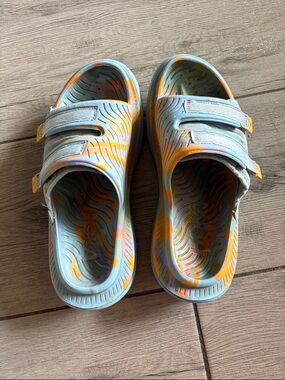 Hoka Women’s Light Blue Sandals with Orange and Yellow Tie-Dye Accents